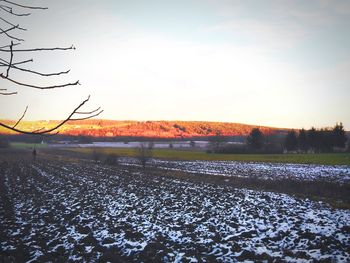 Scenic view of field against sky during sunset