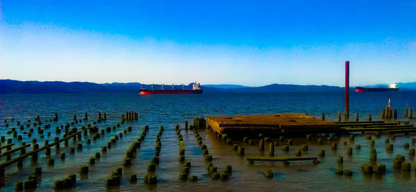 Scenic view of sea against clear blue sky