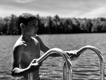 Close-up of man coming out of swimming pool