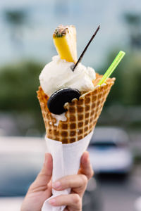 Cropped hand holding ice cream cone