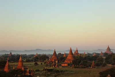 Exterior of temples against clear sky during sunset