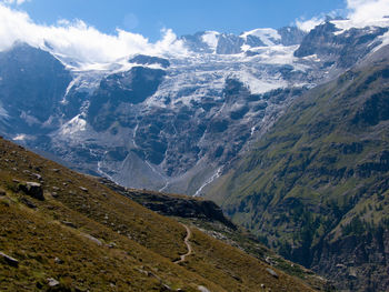 Scenic view of mountains against cloudy sky