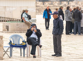 Rear view of people sitting on chair