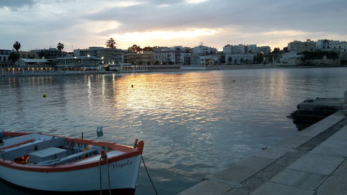 Boats in river with buildings in background