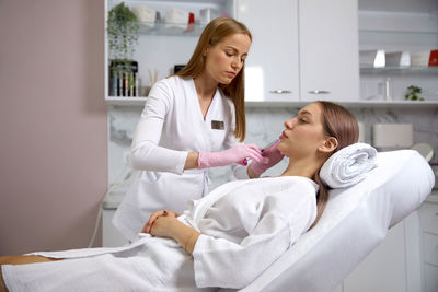 Female doctor examining patient at clinic