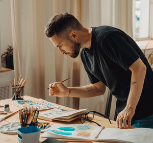 Male painter practicing in workshop