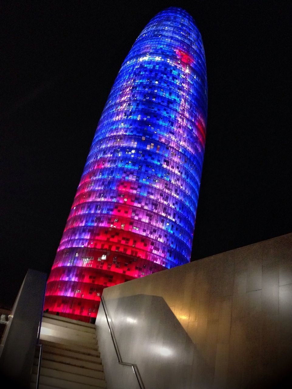 illuminated, night, architecture, built structure, modern, low angle view, indoors, building exterior, pattern, city, copy space, lighting equipment, no people, red, multi colored, light - natural phenomenon, clear sky, blue, design, striped