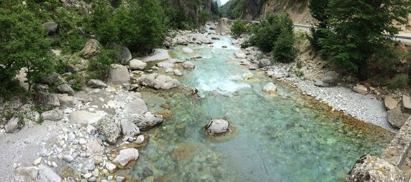 High angle view of stream amidst rocks in forest