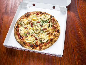 High angle view of pizza served on table