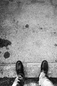 Low section of man standing on puddle