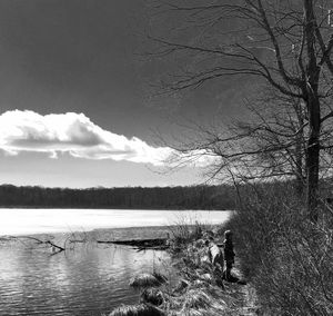 Scenic view of lake against cloudy sky