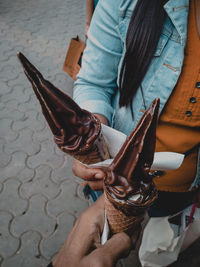 Midsection of woman holding umbrella