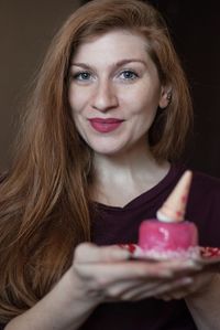 Portrait of smiling young woman eating food