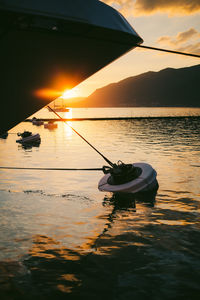 View of boat in lake during sunset