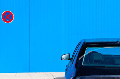 Close-up of car against blue wall