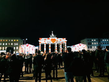 Group of people in front of building at night