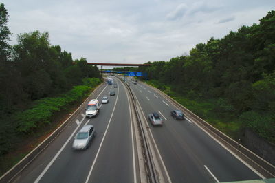 High angle view of cars moving on highway against sky