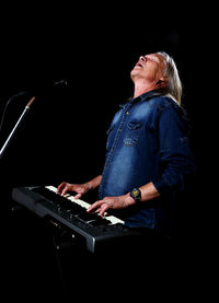 Side view of man playing guitar