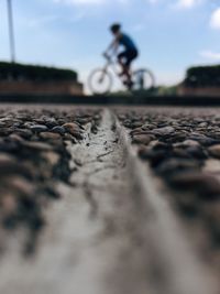 Surface level of person riding bicycle on road