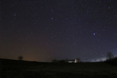 Scenic view of field against sky at night