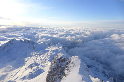 Aerial view of snowcapped mountains against sky