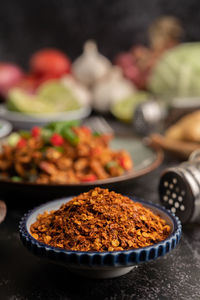 Close-up of red chili peppers in bowl on table