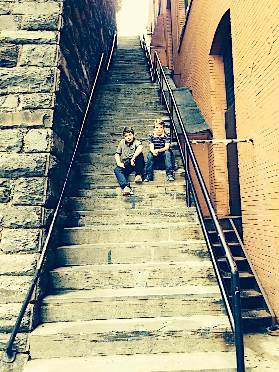 HIGH ANGLE VIEW OF PEOPLE WALKING ON STAIRS