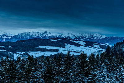 Scenic view of mountains against sky during winter