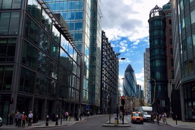 Modern buildings against cloudy sky