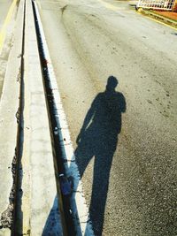 Shadow of person on road