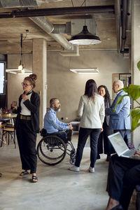 Business colleague discussing during meeting at creative office