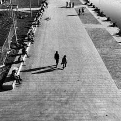 High angle view of people walking on footpath