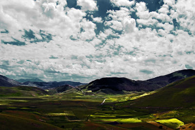 Scenic view of landscape against cloudy sky