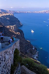 High angle view of sea by mountain against sky