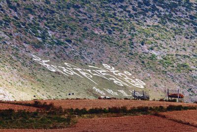 Scenic view of farm against mountain