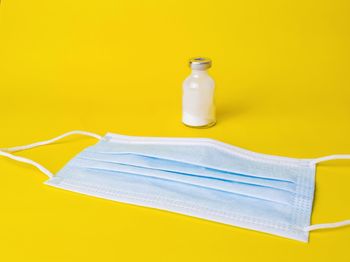Close-up of yellow bottle against white background