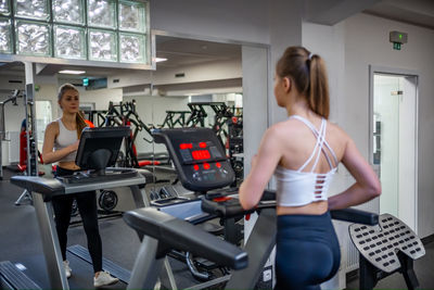 Rear view of woman exercising in gym