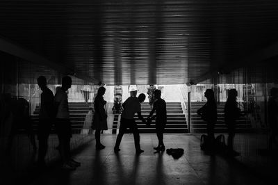 Silhouette people in underground walkway