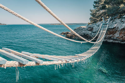 Sailboat in sea against sky