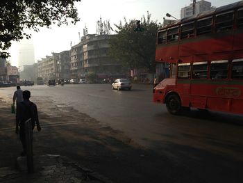 Man in city against sky