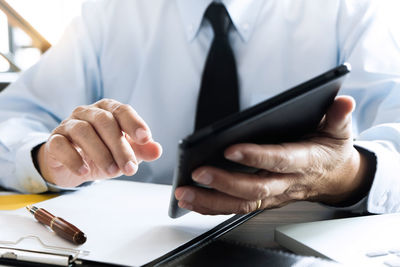 Midsection of man working on table