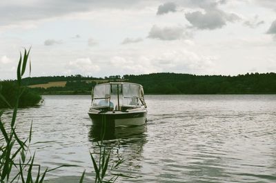 Boat in river against sky