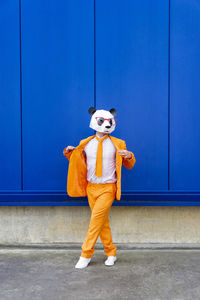 Full length of boy standing against wall