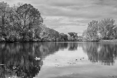 View of calm lake against cloudy sky