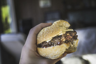 Close-up of hand holding burger