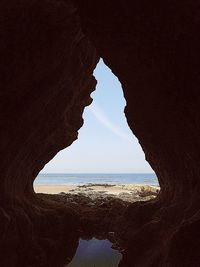 Scenic view of sea seen through cave