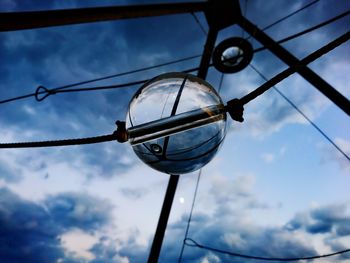 Reflection of cloudy sky on crystal ball in rope
