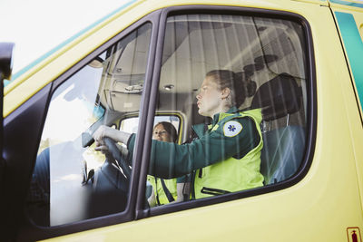 Female paramedics traveling in ambulance