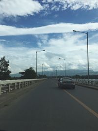 Cars on road against sky