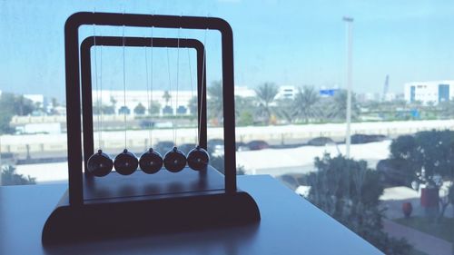 Close-up of table in city against sky